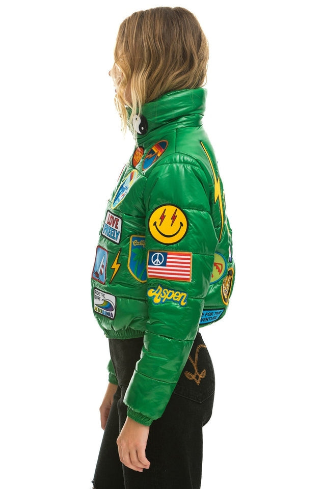 Vintage black glossy puffer jacket with colorful embroidered patches
