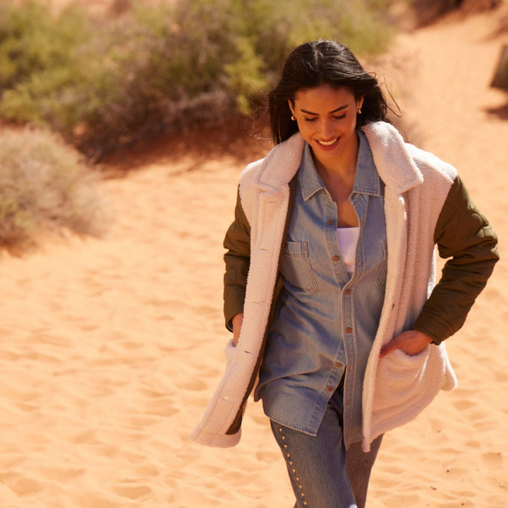 Women’s green quilted mixed media jacket with faux shearling and quilted sleeves.
