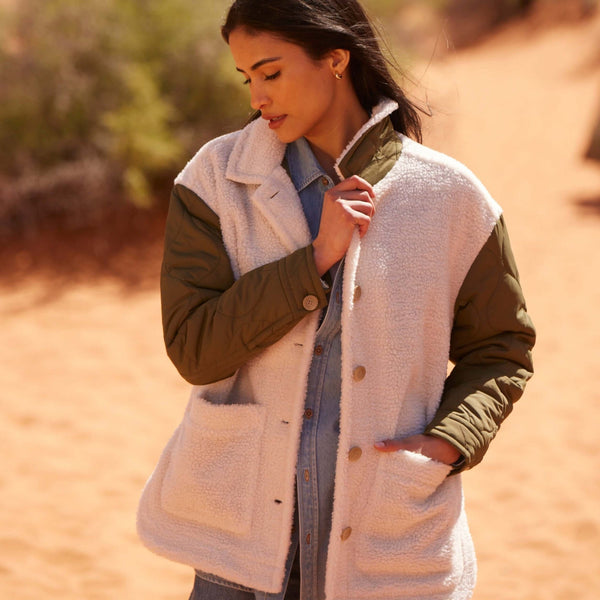Women’s green quilted mixed media jacket with faux shearling and quilted sleeves.
