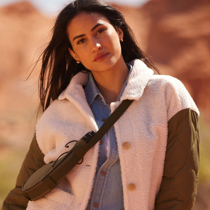 Women’s green quilted mixed media jacket with faux shearling and quilted sleeves.
