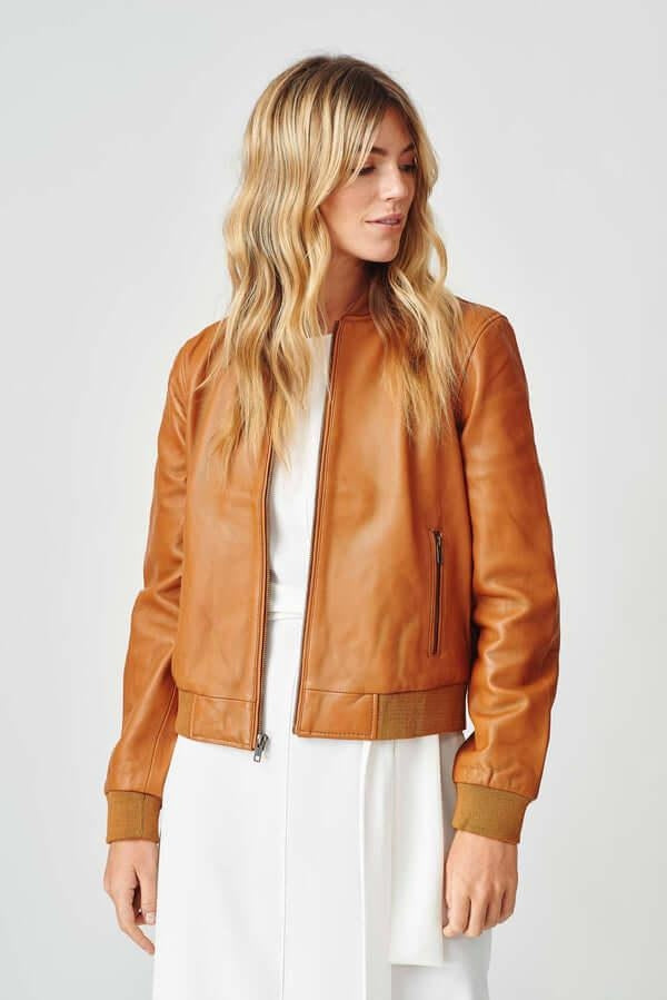 Woman wearing Women’s Bolzano Bomber Leather Jacket outdoors, styled for casual spring/autumn adventures