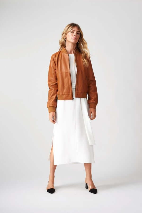 Woman wearing Women’s Bolzano Bomber Leather Jacket outdoors, styled for casual spring/autumn adventures