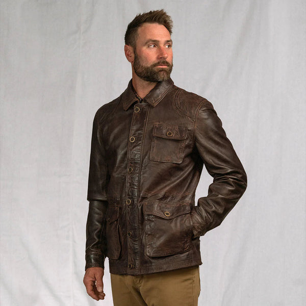Man wearing a brown leather jacket against a plain background